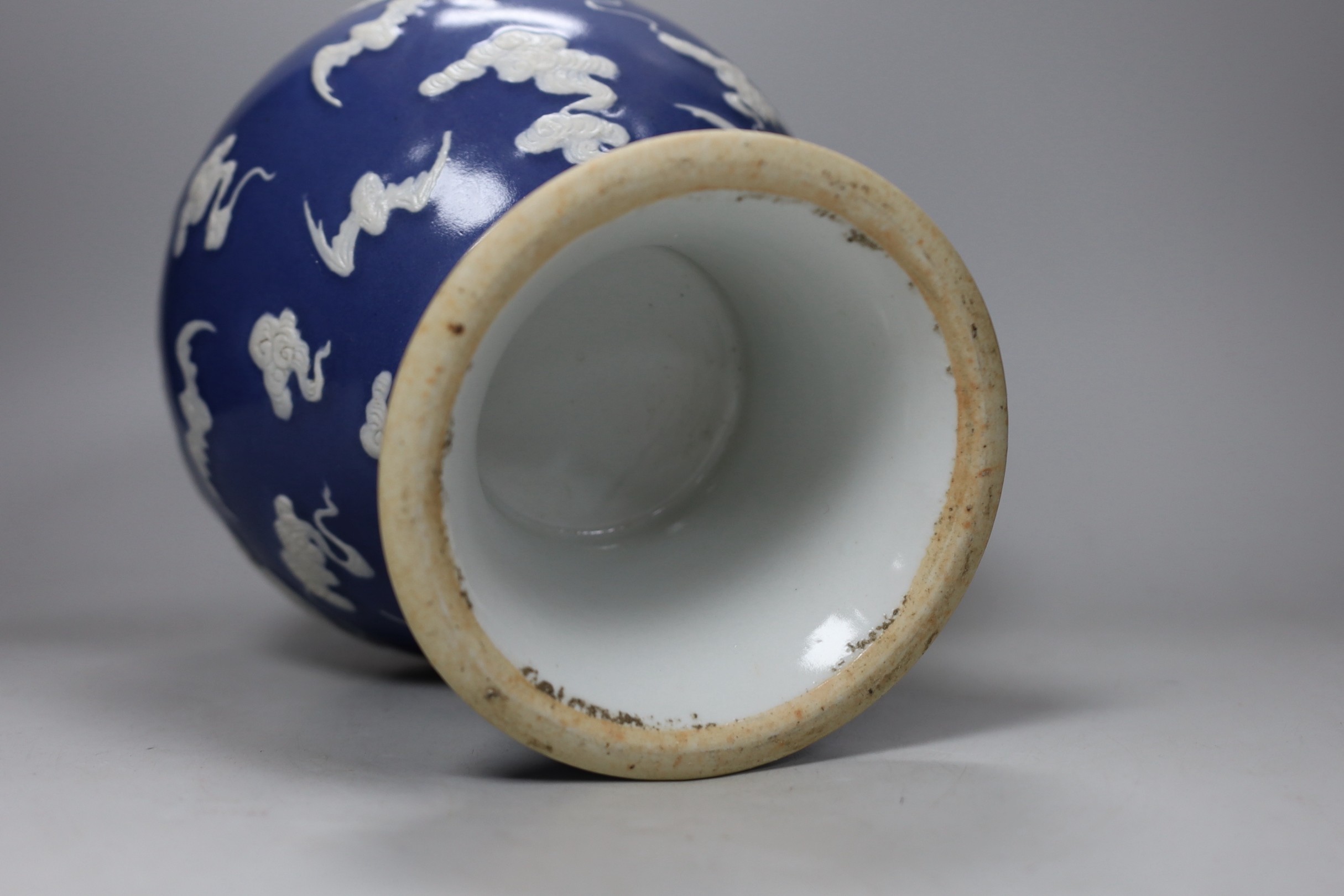 A Chinese slip-decorated blue glazed 'bats' vase 24cm